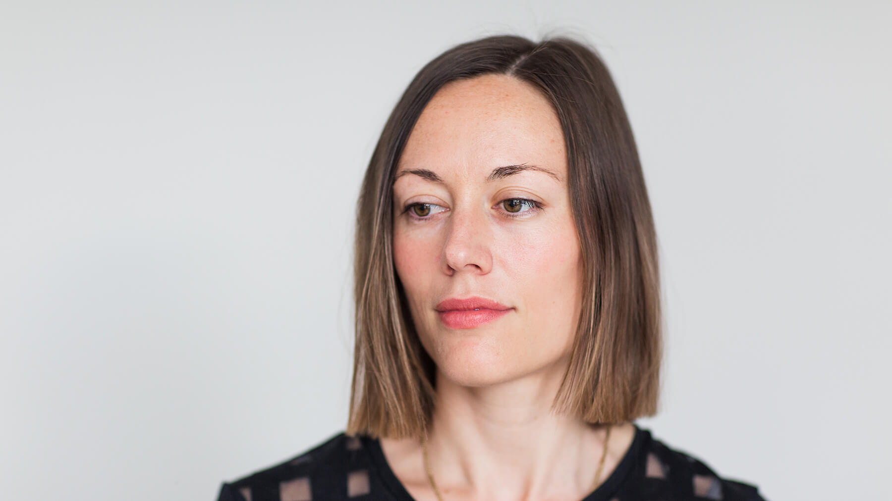 portrait of musician Lisa Illean on light background looking to the right of camera